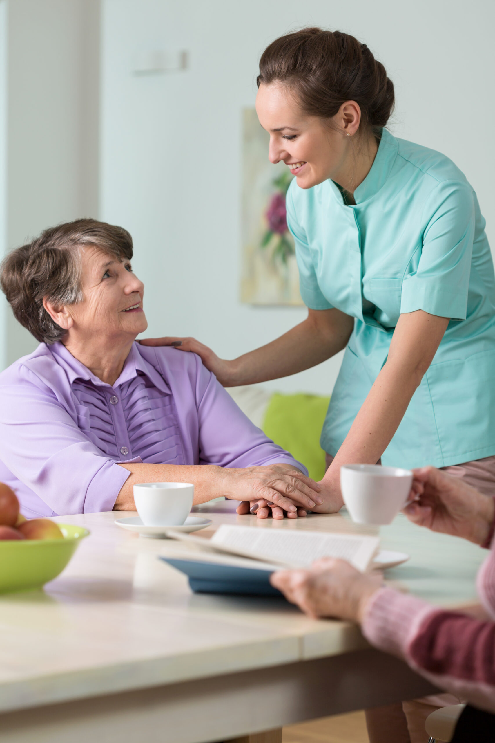 Young beautiful caring nurse and her older ward